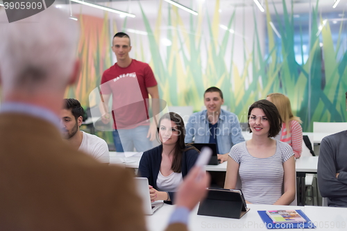 Image of teacher with a group of students in classroom