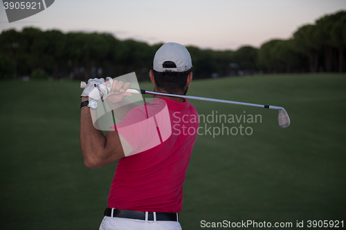 Image of golfer hitting a sand bunker shot on sunset