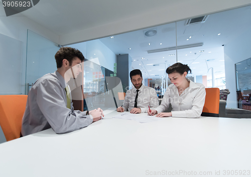 Image of young couple signing contract documents on partners back