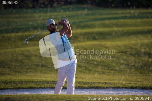 Image of golfer hitting a sand bunker shot on sunset