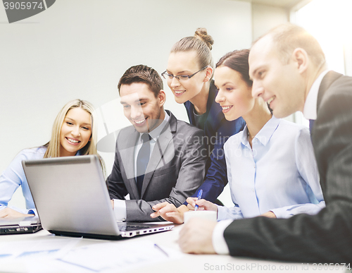 Image of business team with laptop having discussion