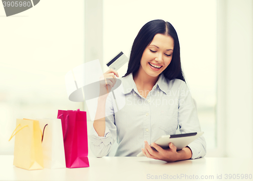 Image of smiling woman with blank screen tablet pc