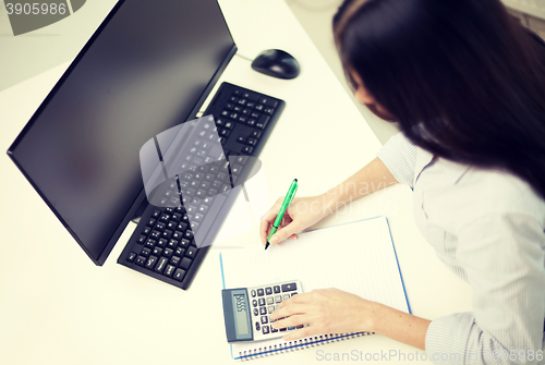 Image of close up of woman with calculator counting