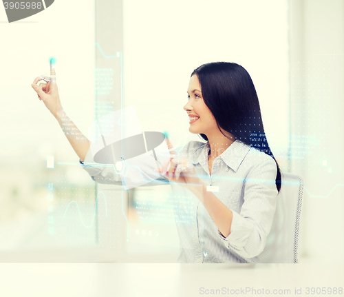 Image of smiling woman pointing to virtual screen