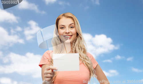 Image of happy woman or teen girl with blank white paper