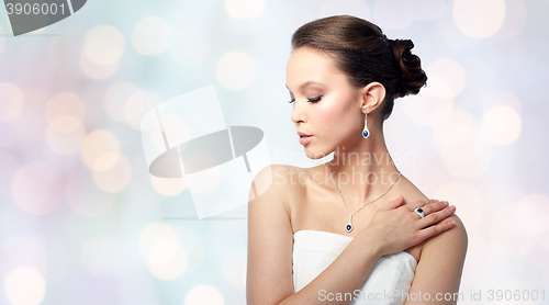 Image of beautiful woman with earring, ring and pendant