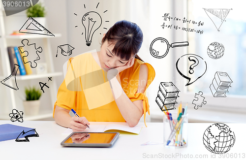 Image of bored asian woman student with tablet pc at home