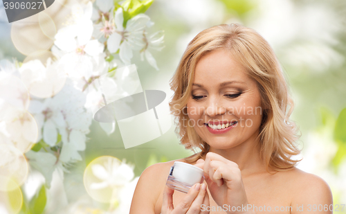 Image of happy woman with cream jar