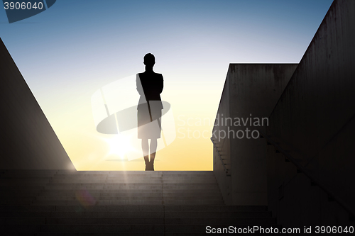 Image of silhouette of business woman with over sun light