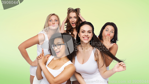 Image of group of happy women in white underwear having fun