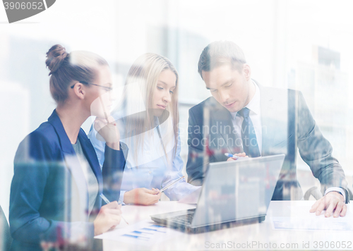 Image of business team with laptop having discussion