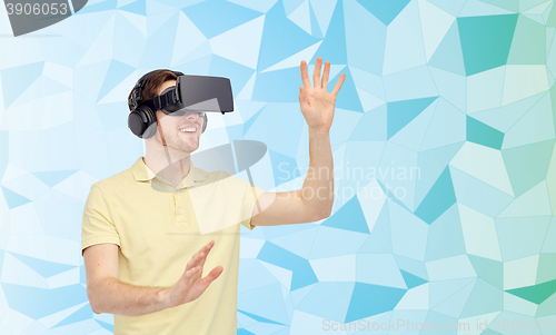 Image of happy man in virtual reality headset or 3d glasses