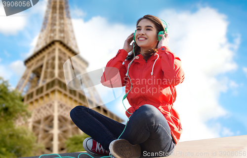 Image of happy young woman in headphones listening to music