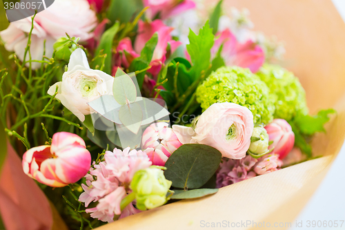 Image of close up of bunch in paper at flower shop