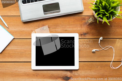 Image of close up of tablet pc computer on wooden table