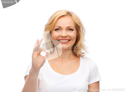 Image of happy woman in white t-shirt showing ok hand sign