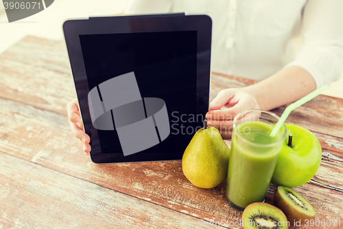 Image of close up of woman hands tablet pc and fruit juice