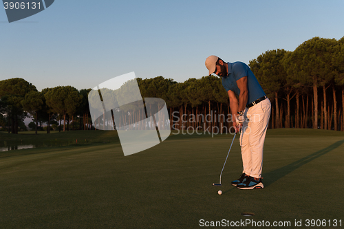 Image of golfer  hitting shot at golf course