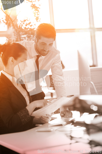 Image of business couple working together on project, sunrise in backgrou