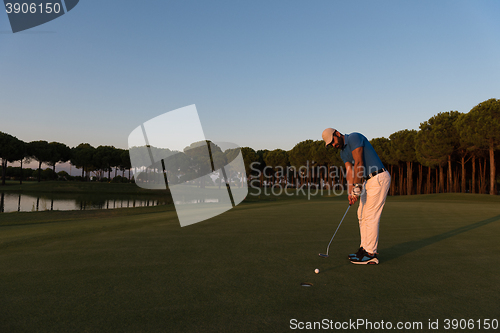 Image of golfer  hitting shot at golf course