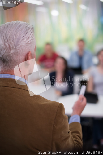 Image of teacher with a group of students in classroom