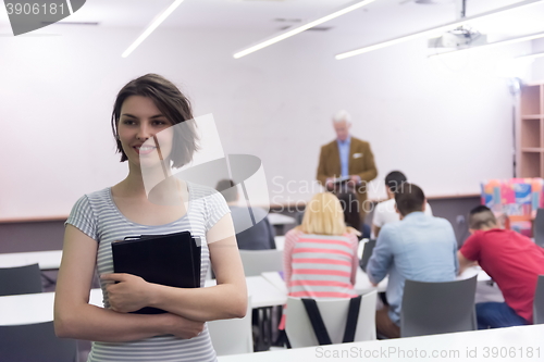 Image of portrait of happy female student in classroom