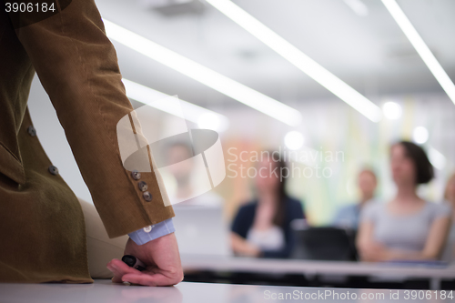 Image of close up of teacher hand while teaching in classroom