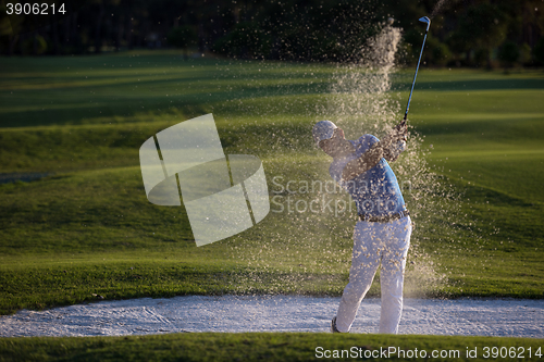 Image of golfer hitting a sand bunker shot on sunset