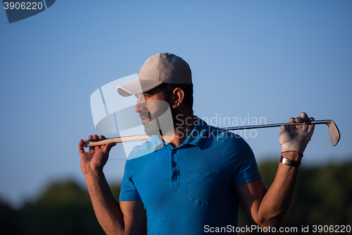 Image of golfer  portrait at golf course on sunset