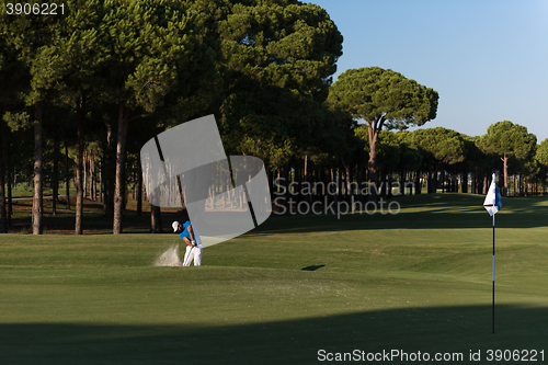 Image of pro golfer hitting a sand bunker shot