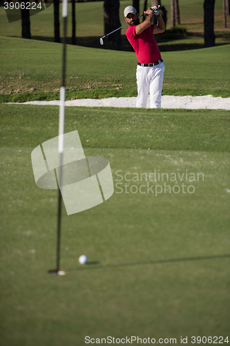 Image of golfer hitting a sand bunker shot