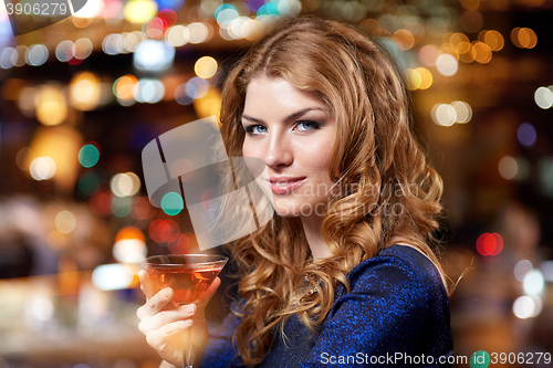 Image of glamorous woman with cocktail at night club or bar