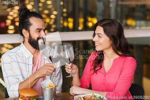 Image of happy couple dining and drink wine at restaurant