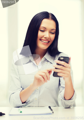 Image of smiling businesswoman or student with smartphone