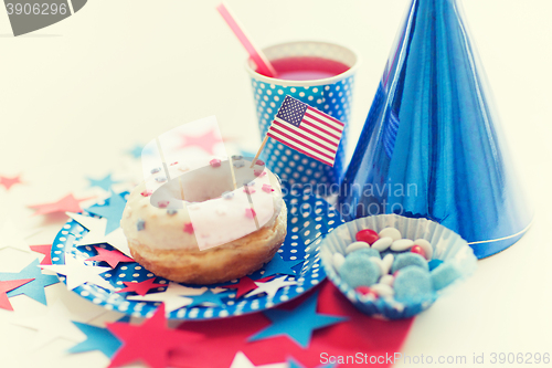 Image of donut with juice and candies on independence day