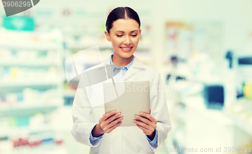 Image of smiling female doctor with tablet pc at drugstore