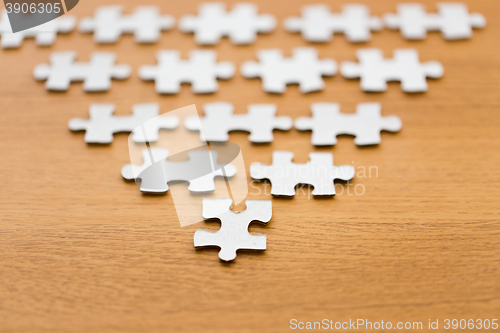 Image of close up of puzzle pieces on wooden surface