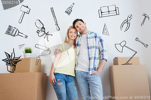 Image of smiling couple with big boxes moving to new home