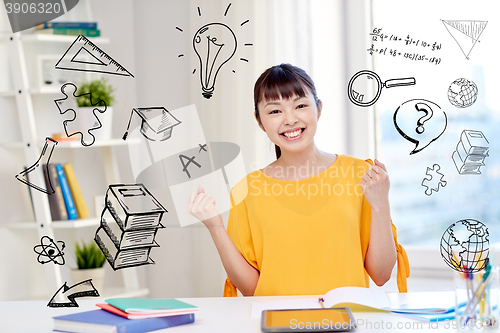 Image of happy asian young woman student learning at home