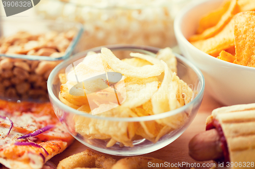 Image of close up of crunchy potato crisps in glass bowl