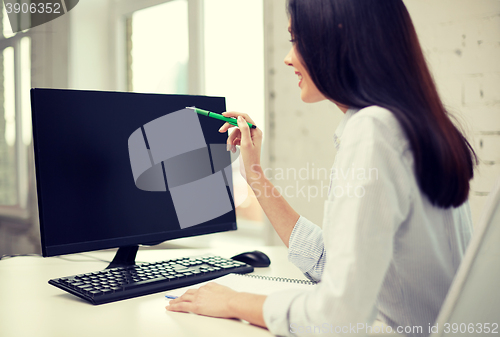 Image of close up of woman with computer monitor in office