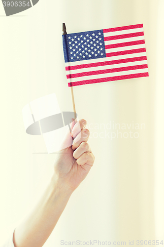 Image of close up of woman holding american flag in hand