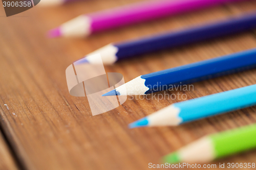 Image of close up of crayons or color pencils on wood