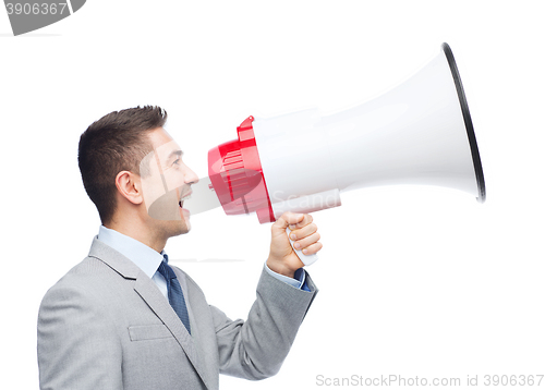 Image of happy businessman in suit speaking to megaphone