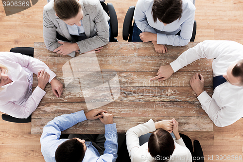 Image of close up of business team sitting at table