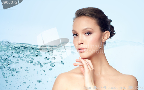 Image of face of beautiful asian woman with golden ring