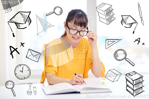 Image of happy asian young woman student learning at home