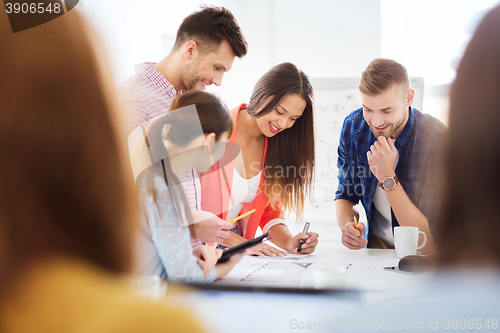 Image of happy creative team or students working at office