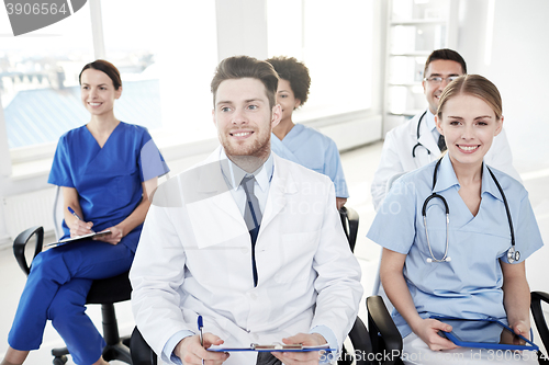 Image of group of happy doctors on seminar at hospital