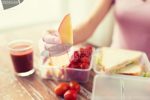 Image of close up of woman with food in plastic container